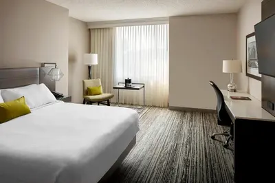a hotel room with a bed and a desk at Marriott Cincinnati Airport in Hebron