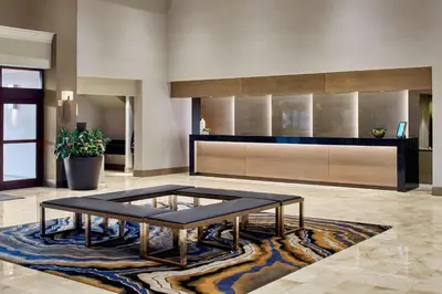 a living room with a coffee table on a rug at Marriott Cincinnati Airport in Hebron