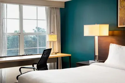 a hotel room with a bed and a desk and a window at Residence Inn Cincinnati Airport in Erlanger