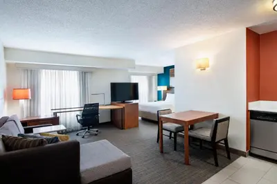 a hotel room with a bed and a living room at Residence Inn Cincinnati Airport in Erlanger
