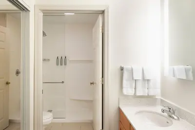 a white bathroom with a sink and a shower at Residence Inn Cincinnati Airport in Erlanger