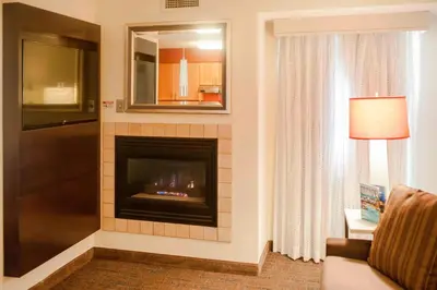 a living room with a fireplace and a couch at Residence Inn Cincinnati Airport in Erlanger