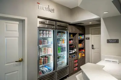a room with a refrigerator filled with food and drinks at Residence Inn Cincinnati Airport in Erlanger