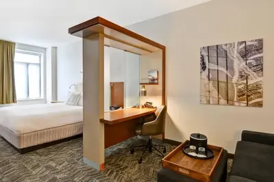 a hotel room with a desk and a bed at SpringHill Suites by Marriott Cincinnati Midtown in Cincinnati