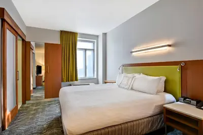 a hotel room with a bed and a window at SpringHill Suites by Marriott Cincinnati Midtown in Cincinnati