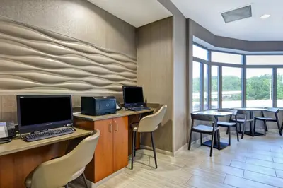an office with a desk with a computer and chairs at SpringHill Suites by Marriott Cincinnati Midtown in Cincinnati