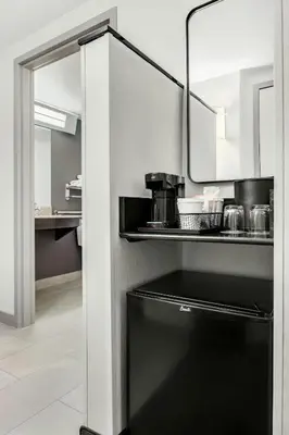 a black dishwasher in a kitchen with a mirror at Courtyard Hamilton in Hamilton