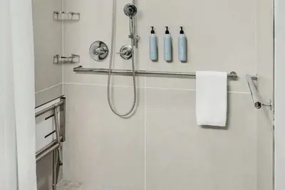 a bathroom with a shower with a shower head at Courtyard Hamilton in Hamilton