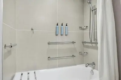 a bathroom with a shower with a bath tub at Courtyard Hamilton in Hamilton
