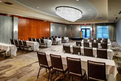 a conference room with tables and chairs in it at Courtyard Hamilton in Hamilton