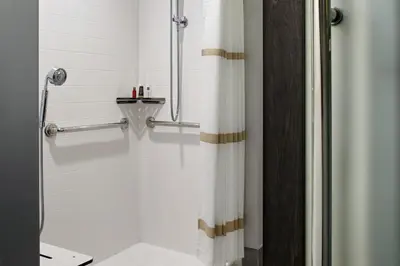 a bathroom with a shower with a shower curtain at Marriott Cincinnati Northeast in Mason