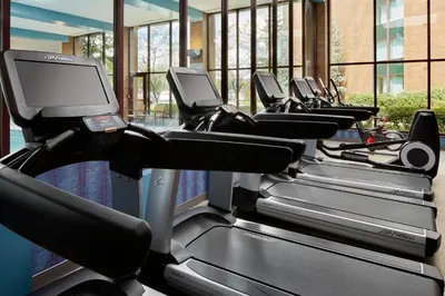 a row of treadmills in a gym at Marriott Cincinnati Northeast in Mason