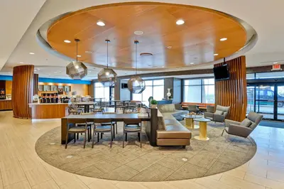 a dining room with a table and chairs at SpringHill Suites Cincinnati Airport South in Florence