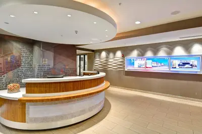 a lobby of a store with a circular counter and a counter at SpringHill Suites Cincinnati Airport South in Florence