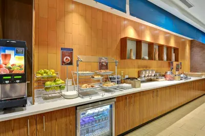 a buffet line in a restaurant with food at SpringHill Suites Cincinnati Airport South in Florence