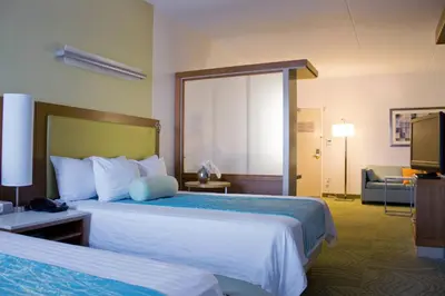 a hotel room with two beds and a television at SpringHill Suites Cincinnati Airport South in Florence