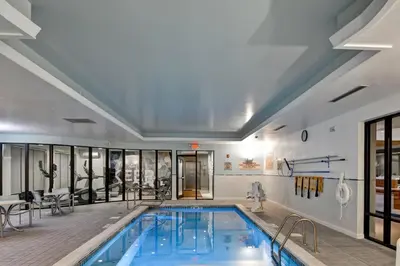 a pool in a building with a swimming pool at SpringHill Suites Cincinnati Airport South in Florence