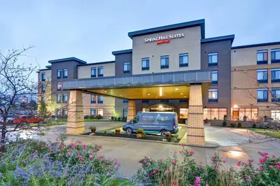 a van parked in a parking lot in front of a hotel at SpringHill Suites Cincinnati Airport South in Florence