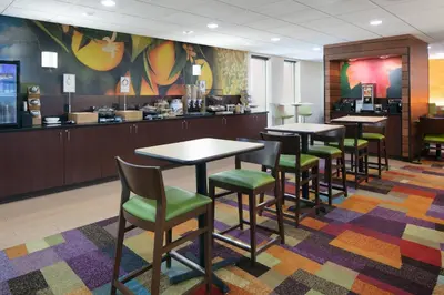a waiting area with tables and chairs in a restaurant at Chester Inn & Suites in Sharonville