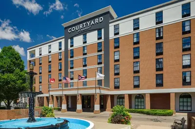an exterior view of a hotel with american flags at Courtyard by Marriott Springfield Downtown in Springfield