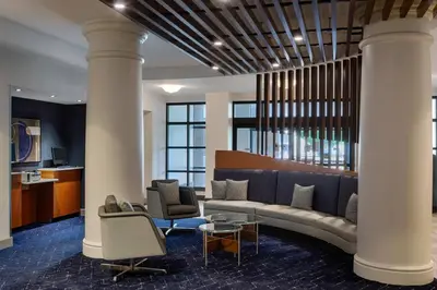 a lobby with a couch and chairs and columns at Courtyard by Marriott Springfield Downtown in Springfield