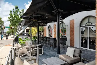 a patio with tables and chairs on a building at Courtyard by Marriott Springfield Downtown in Springfield