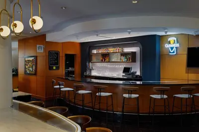 a bar in a restaurant with bar stools at Courtyard by Marriott Springfield Downtown in Springfield