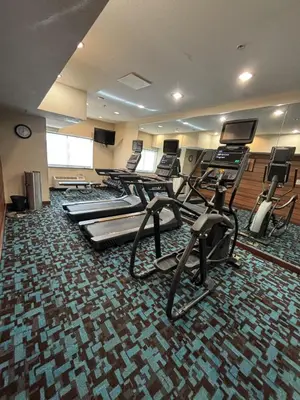 a gym with several treadmills and elliptical machines at Fairfield Inn & Suites Springfield in Springfield