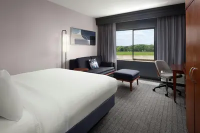 a hotel room with a bed and a desk at Courtyard Dayton-University of Dayton in Dayton