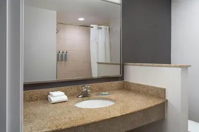 a bathroom with a sink and a mirror at Courtyard Dayton-University of Dayton in Dayton