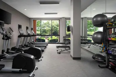 a gym with a row of treadmills and machines at Courtyard Dayton-University of Dayton in Dayton