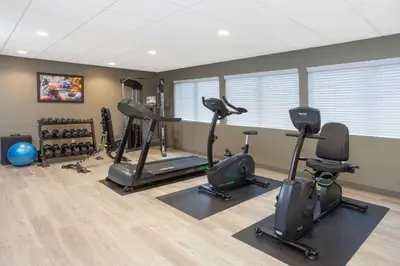 a gym with several treadmills and exercise bikes at Wyndham Garden Fort Wayne in Fort Wayne