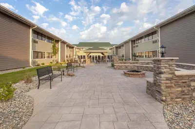a courtyard of a building with benches and benches at Wyndham Garden Fort Wayne in Fort Wayne