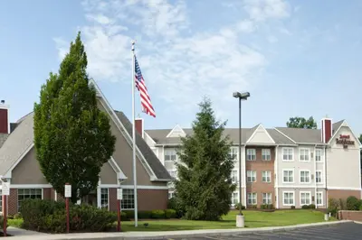 a building with an american flag in front of it at Residence Inn by Marriott Fort Wayne Southwest in Fort Wayne