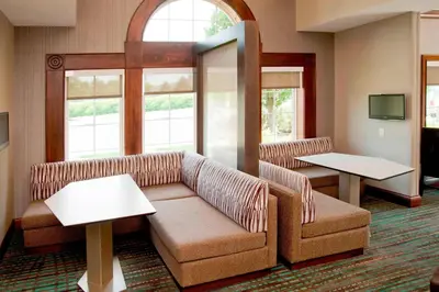 a waiting room with a couch and two tables at Residence Inn by Marriott Fort Wayne Southwest in Fort Wayne