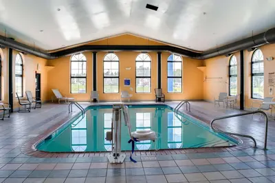 a swimming pool with a chair in a building at Motel 6-Richmond, IN in Richmond
