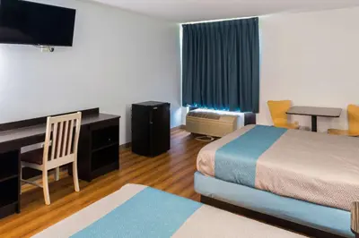 a hotel room with two beds and a desk at Motel 6-Richmond, IN in Richmond