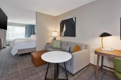 a hotel room with a couch and a bed at Staybridge Suites Pittsburgh Airport by IHG in Pittsburgh