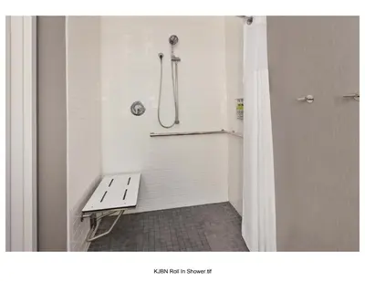a shower with a bench in a bathroom at Staybridge Suites Pittsburgh Airport by IHG in Pittsburgh