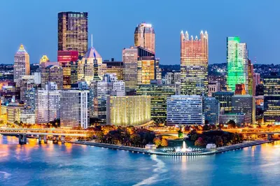 a view of a city skyline at night at Staybridge Suites Pittsburgh Airport by IHG in Pittsburgh