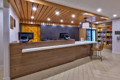 a lobby of a store with a counter and a chair at Staybridge Suites Pittsburgh Airport by IHG in Pittsburgh