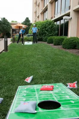 two men standing in the grass with a green table at Courtyard by Marriott Canton in North Canton