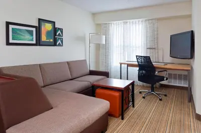 a living room with a couch and a desk with a computer at Residence Inn Canton in North Canton