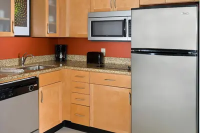 a kitchen with a white refrigerator and a sink at Residence Inn Canton in North Canton