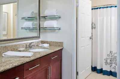 a bathroom with a sink and a mirror and a shower at Residence Inn Canton in North Canton
