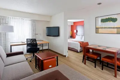 a hotel room with a bed and a room with a desk at Residence Inn Canton in North Canton