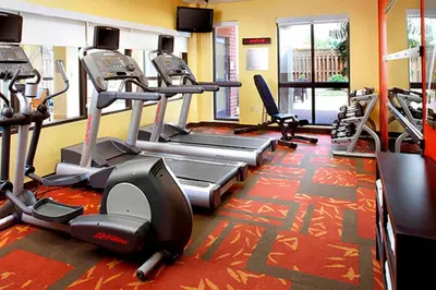 a gym with treadmills and elliptical machines at Courtyard by Marriott Akron Stow in Stow