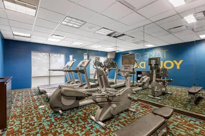 a gym with treadmills and elliptical machines at Comfort Inn & Suites Akron South in Akron