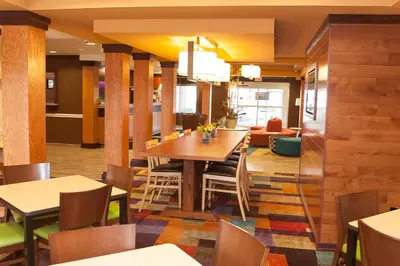 a dining room with a table and chairs at Comfort Inn & Suites Akron South in Akron