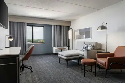 a hotel room with a waiting area with a living room at Courtyard Cleveland Beachwood in Beachwood
